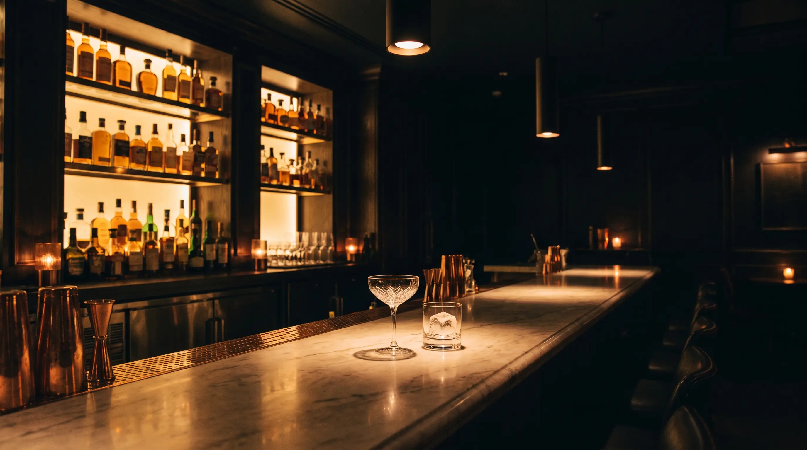 The marble bar backlit with amber spirits